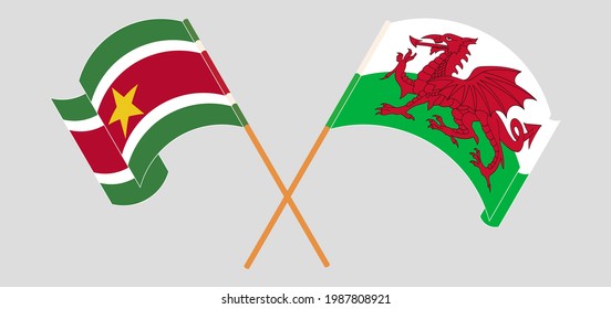 Crossed and waving flags of Suriname and Wales