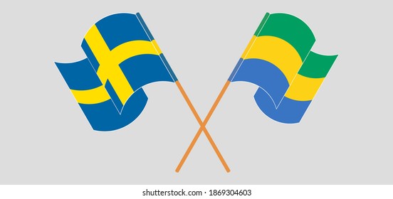 Crossed and waving flags of Sweden and Gabon