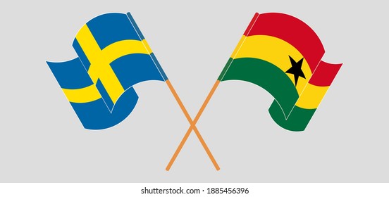 Crossed and waving flags of Sweden and Ghana