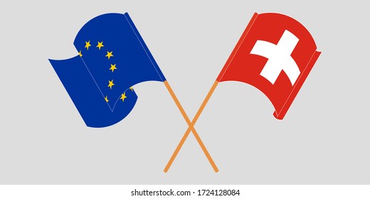 Crossed and waving flags of Switzerland and the EU