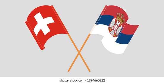 Crossed and waving flags of Switzerland and Serbia