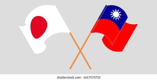 Crossed and waving flags of Taiwan and Japan