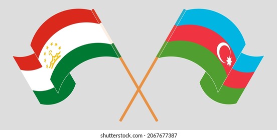 Crossed and waving flags of Tajikistan and Azerbaijan