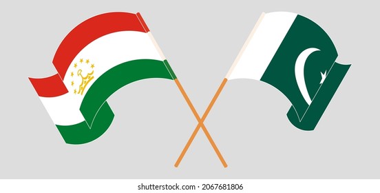 Crossed and waving flags of Tajikistan and Pakistan