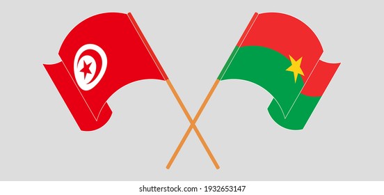 Crossed and waving flags of Tunisia and Burkina Faso
