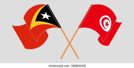 Crossed and waving flags of Tunisia and East Timor