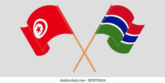 Crossed and waving flags of Tunisia and the Gambia