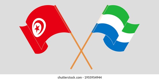 Crossed and waving flags of Tunisia and Sierra Leone