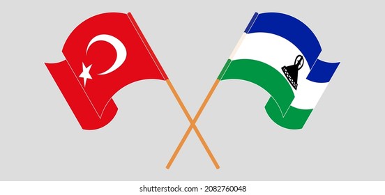 Crossed and waving flags of Turkey and Kingdom of Lesotho. Vector illustration

