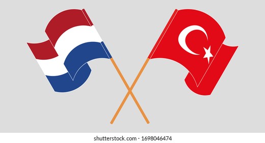 Crossed and waving flags of Turkey and the Netherlands