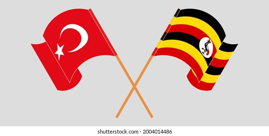 Crossed and waving flags of Turkey and Uganda