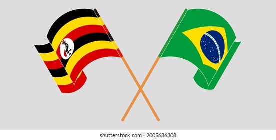 Banderas cruzadas y ondeando banderas de Uganda y Brasil