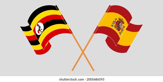 Crossed and waving flags of Uganda and Spain