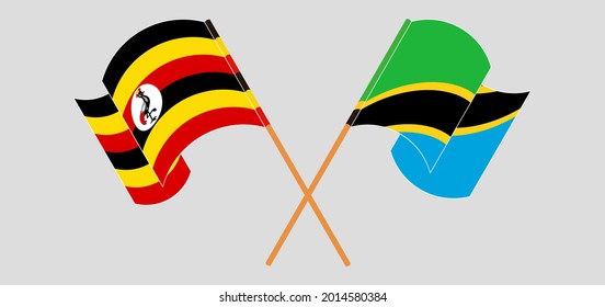 Crossed and waving flags of Uganda and Tanzania