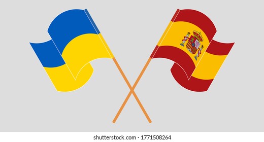 Crossed and waving flags of the Ukraine and Spain