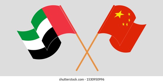 Crossed and waving flags of the United Arab Emirates and China