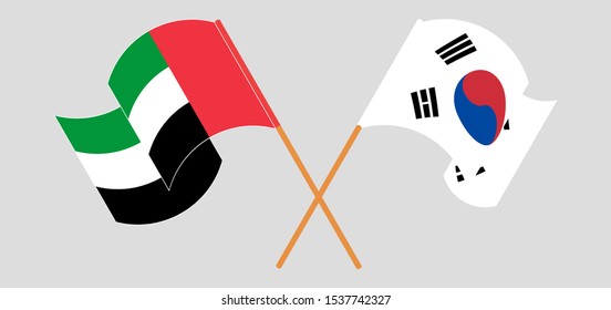 Crossed and waving flags of the United Arab Emirates and South Korea. Vector illustration
