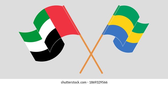 Crossed and waving flags of the United Arab Emirates and Gabon