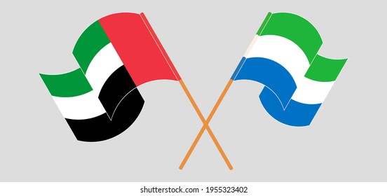 Banderas cruzadas y ondeando banderas de los Emiratos Árabes Unidos y Sierra Leona