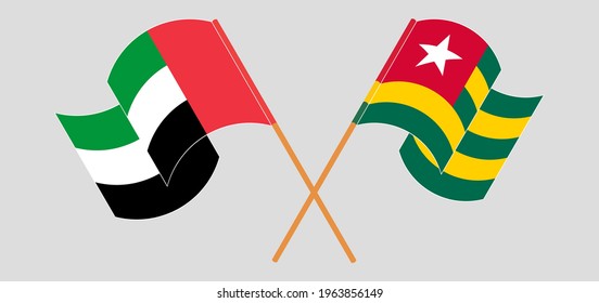 Crossed and waving flags of the United Arab Emirates and Togo