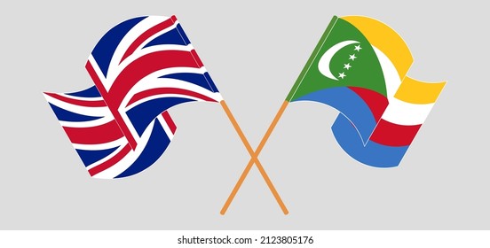 Crossed and waving flags of United Kingdom and Comoros. Vector illustration
