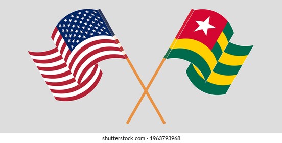 Crossed and waving flags of the USA and Togo
