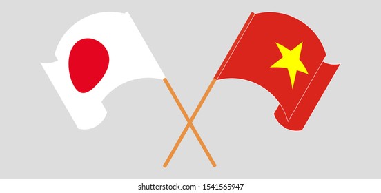 Crossed and waving flags of Vietnam and Japan