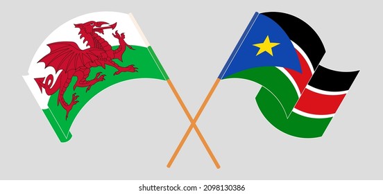 Crossed and waving flags of Wales and South Sudan. Vector illustration
