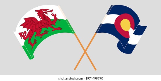 Crossed and waving flags of Wales and The State of Colorado