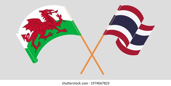 Crossed and waving flags of Wales and Thailand