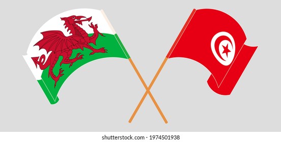 Crossed and waving flags of Wales and Tunisia