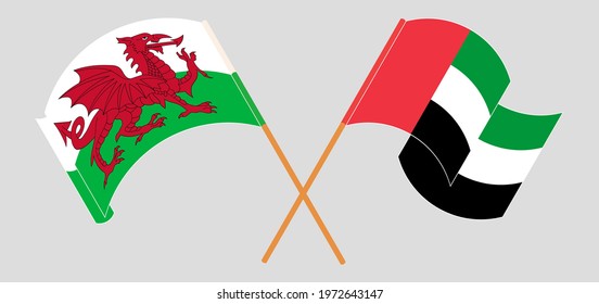 Crossed and waving flags of Wales and the United Arab Emirates