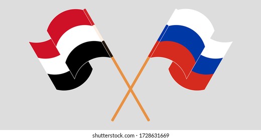 Crossed and waving flags of Yemen and Russia