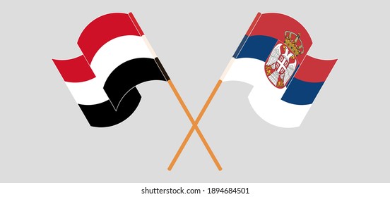 Crossed and waving flags of Yemen and Serbia