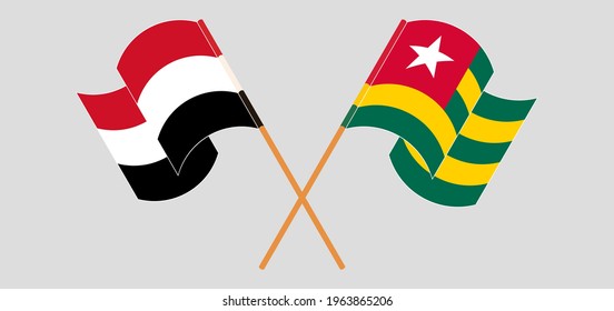 Crossed and waving flags of Yemen and Togo