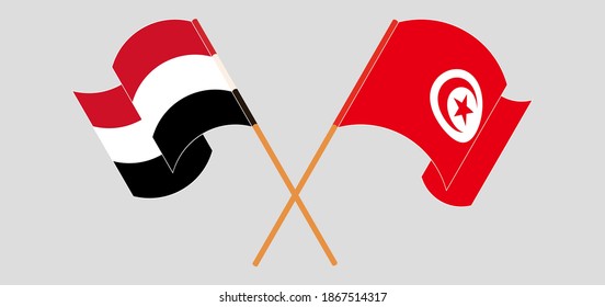 Crossed and waving flags of Yemen and Tunisia