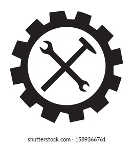 crossed wrench and hammer tool inside cogwheel 
