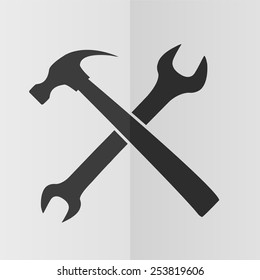 Crossed wrench and hammer vector icon. Effect of folded paper. Flat design