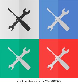 Crossed wrench and screwdriver vector icon. Effect of folded paper. Colored (red, blue, green) illustrations. Flat design