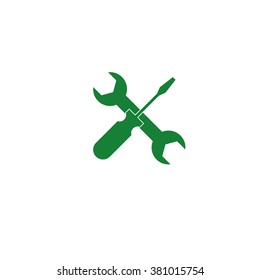 Crossed wrench and screwdriver. Vector icon green
