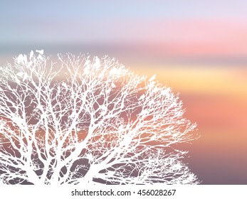 Crowd birds hold on tree stick white silhouette big tree on blur orange sunset background, snow forest backdrop scenery winter season.