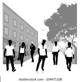 Crowd of people walking on a street.