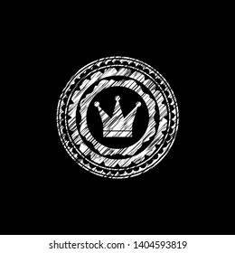 crown icon inside chalkboard emblem on black board