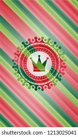 crown icon inside christmas colors emblem.
