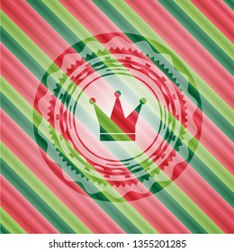 crown icon inside christmas style emblem.