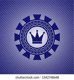 crown icon inside emblem with jean background