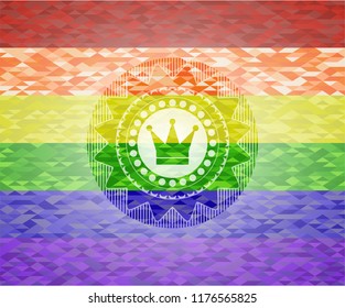 crown icon inside emblem on mosaic background with the colors of the LGBT flag