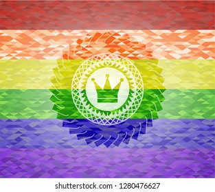 crown icon inside emblem on mosaic background with the colors of the LGBT flag