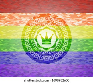 crown icon inside emblem on mosaic background with the colors of the LGBT flag