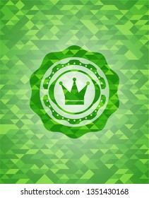 crown icon inside green emblem with mosaic ecological style background